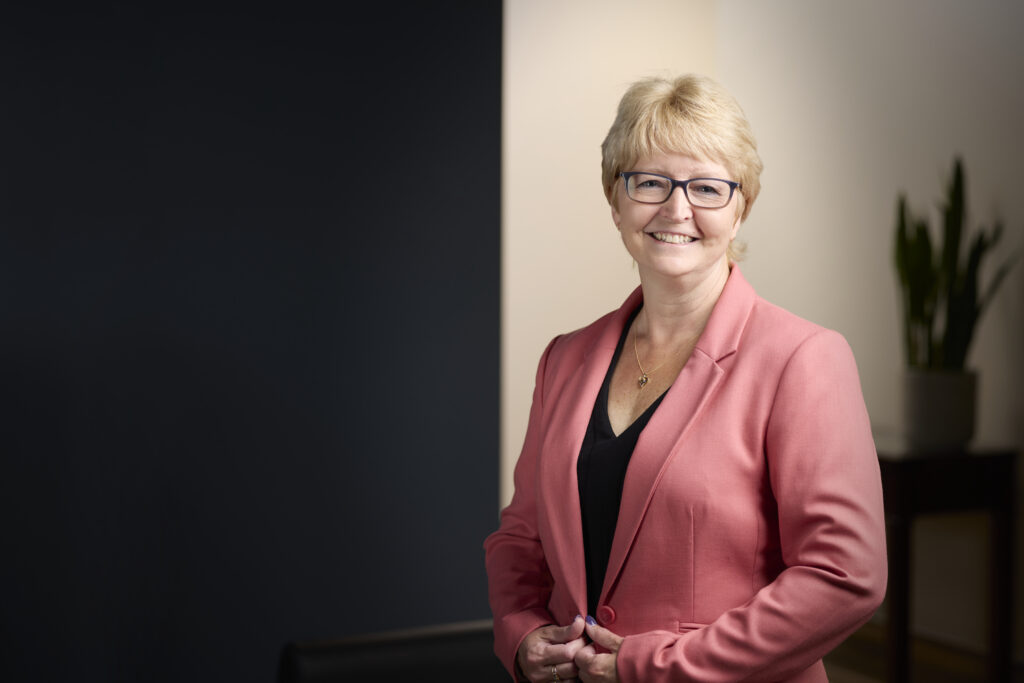An image of Karen Raymond, PCP, Payroll & Bookkeeping Specialist, QBO Certified Pro Advisor in the lobby of MW&Co. CPA firm in Woodstock